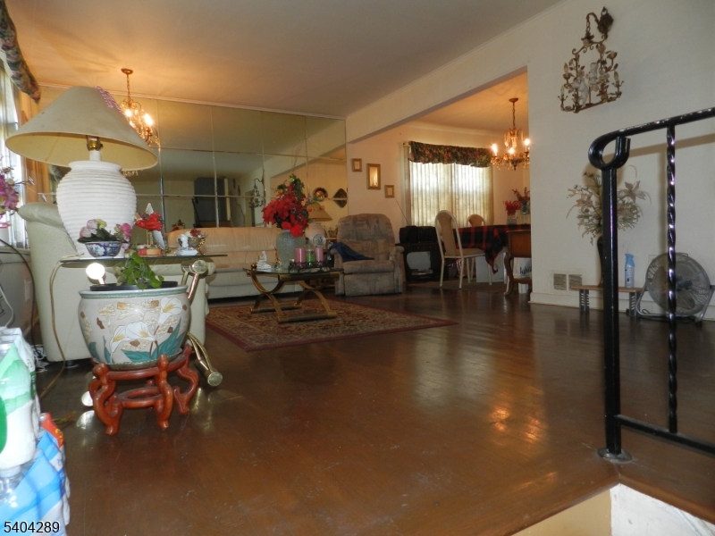 2442 Terrill Road Union, NJ 07083 - Photo 2 of 15 a living room with lots of furniture and a chandelier