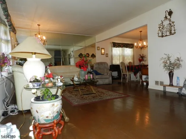 a living room filled with furniture and a chandelier