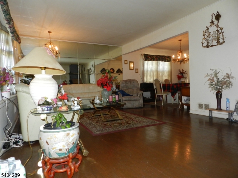 2442 Terrill Road Union, NJ 07083 - Photo 3 of 15 a living room filled with furniture and a chandelier
