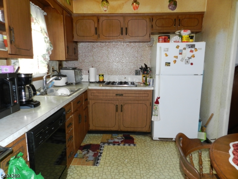 2442 Terrill Road Union, NJ 07083 - Photo 9 of 15 a kitchen with a sink a stove and a refrigerator
