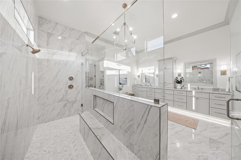 724 Cooper Trail Weatherford, TX 76087 - Photo 26 of 37 Spacious bathroom featuring a large glass-enclosed shower with full-height marble-look tiling and a built-in bench