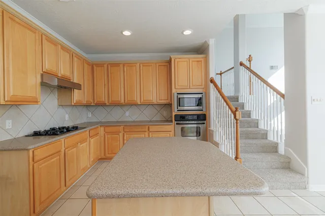 a kitchen with stainless steel appliances granite countertop a refrigerator sink and cabinets