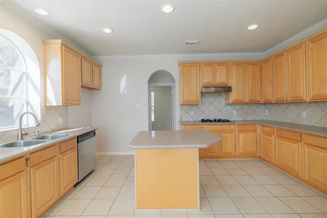 a kitchen with granite countertop a sink and a stove top oven