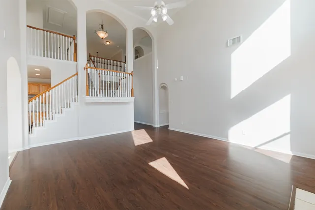 a view of a hallway with wooden floor and entryway