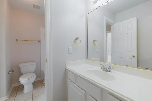 a bathroom with a sink toilet and a mirror