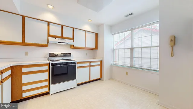 a kitchen with stainless steel appliances granite countertop a stove and a sink