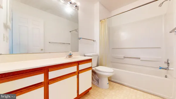 a white toilet sitting next to a bath tub