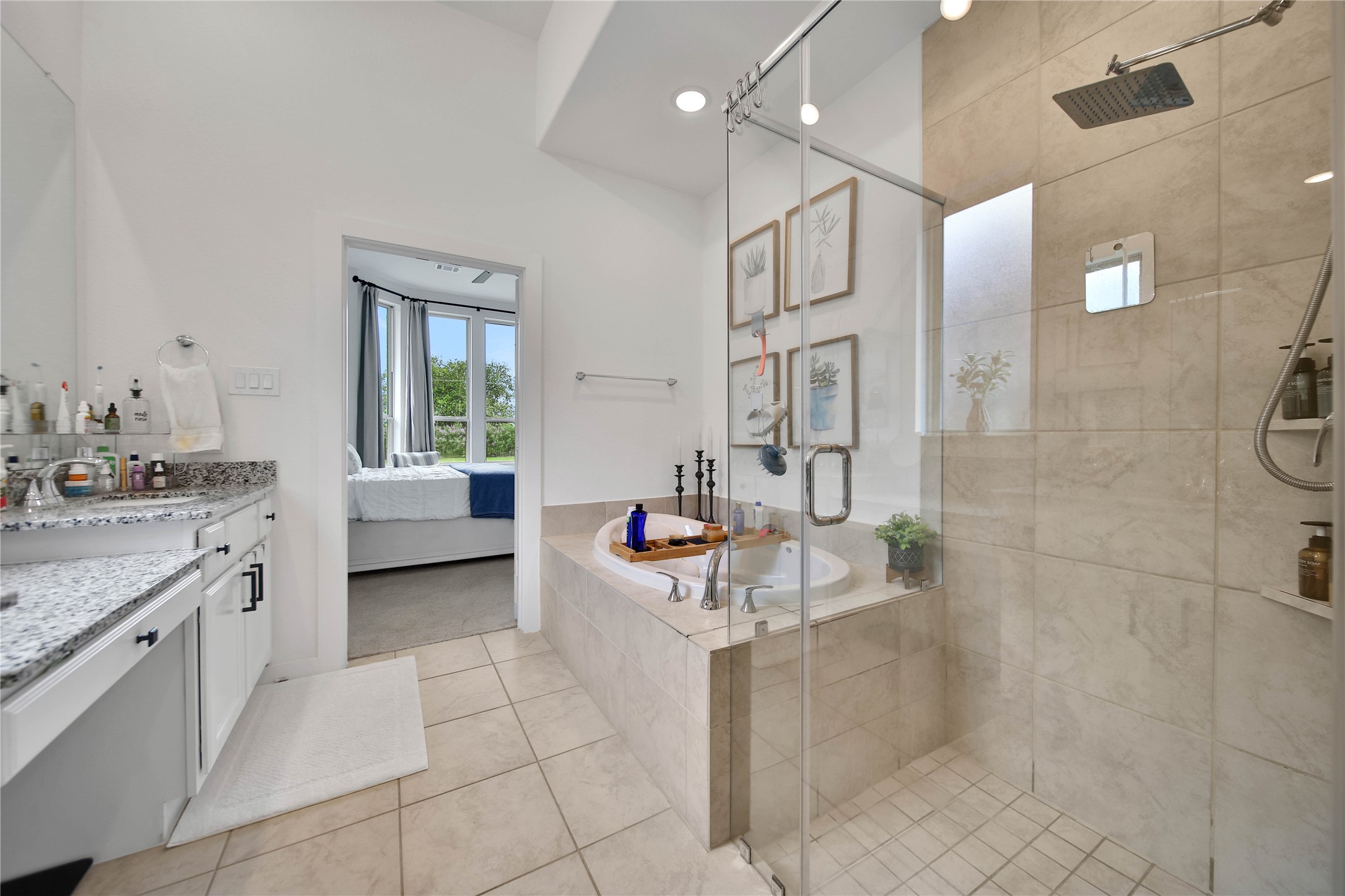 4103 Shackleton Court Rosharon, TX 77583 - Photo 14 of 32 Primary bathroom offers custom cabinetry, oversized closet space, jacuzzi tub, vanity and dual sinks with stand alone shower