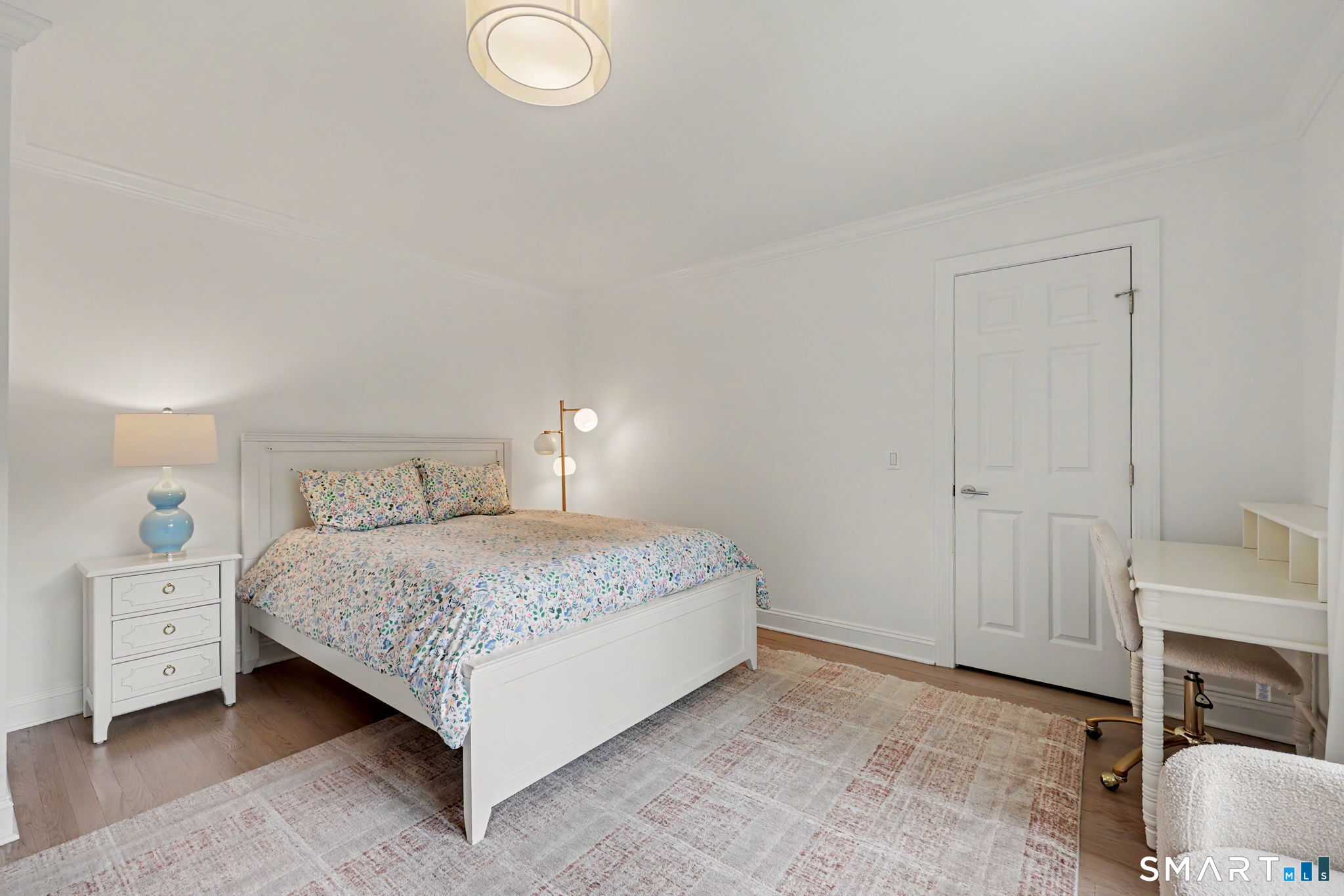10 Side Hill Road Westport, CT 06880 - Photo 27 of 40 a bedroom with a bed and a chair