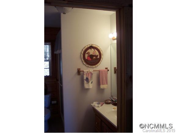 460 Barn Cove Road Clyde, NC 28721 - Photo 16 of 24 a picture of a bathroom with a sink and a mirror