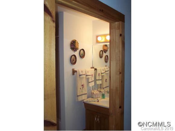 460 Barn Cove Road Clyde, NC 28721 - Photo 17 of 24 a picture of a bathroom with a shower and a mirror