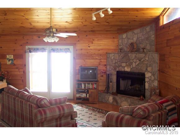 460 Barn Cove Road Clyde, NC 28721 - Photo 18 of 24 a living room with furniture and a fireplace