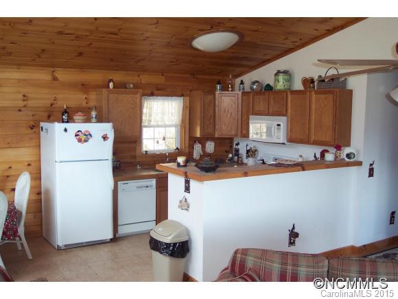 460 Barn Cove Road Clyde, NC 28721 - Photo 21 of 24 a kitchen with refrigerator and cabinets