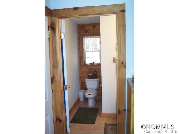 460 Barn Cove Road Clyde, NC 28721 - Photo 24 of 24 a view of a hallway with toilet and a window