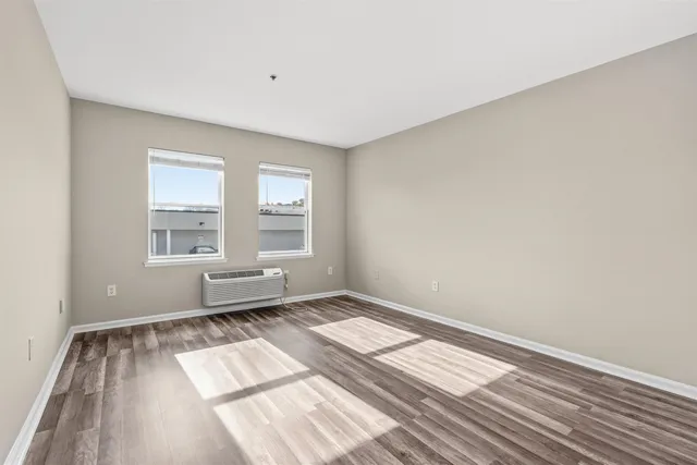 wooden floor in an empty room with a window