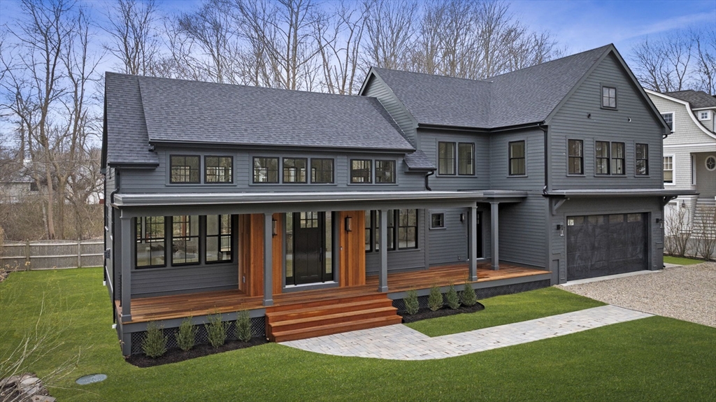 a view of a house with a yard and a garden