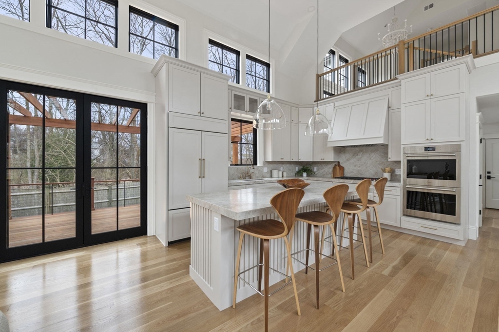 16 Liberty Road Marblehead, MA 01945 - Photo 13 of 42 a kitchen with stainless steel appliances granite countertop a stove a sink and a refrigerator