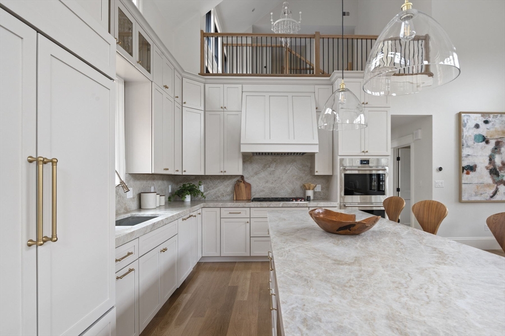 16 Liberty Road Marblehead, MA 01945 - Photo 14 of 42 a kitchen with stainless steel appliances a white cabinets and chandelier