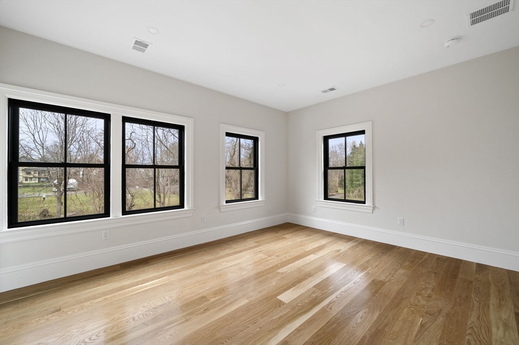 16 Liberty Road Marblehead, MA 01945 - Photo 27 of 42 a view of an empty room with a window and wooden floor