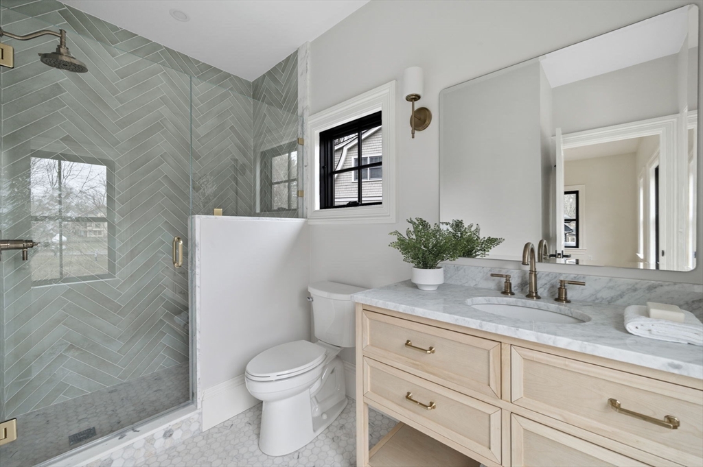 16 Liberty Road Marblehead, MA 01945 - Photo 30 of 42 a bathroom with a granite countertop toilet sink and mirror
