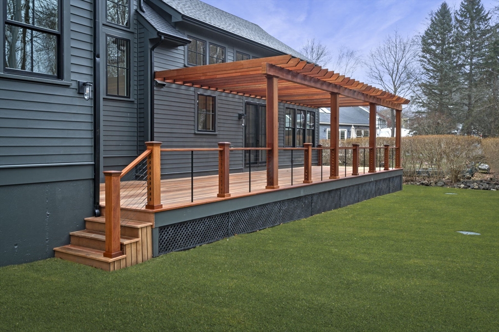 16 Liberty Road Marblehead, MA 01945 - Photo 3 of 42 a backyard of a house with wooden floor and fence