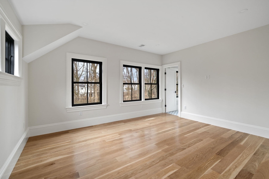 16 Liberty Road Marblehead, MA 01945 - Photo 31 of 42 a view of an empty room with a window and wooden floor
