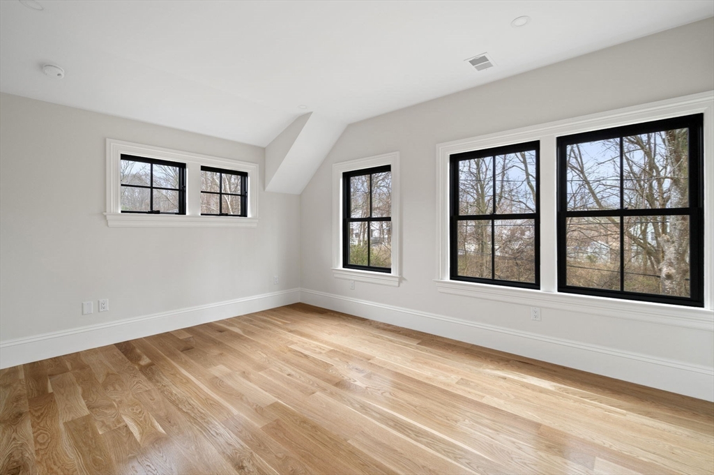 16 Liberty Road Marblehead, MA 01945 - Photo 32 of 42 a view of an empty room with a window and wooden floor