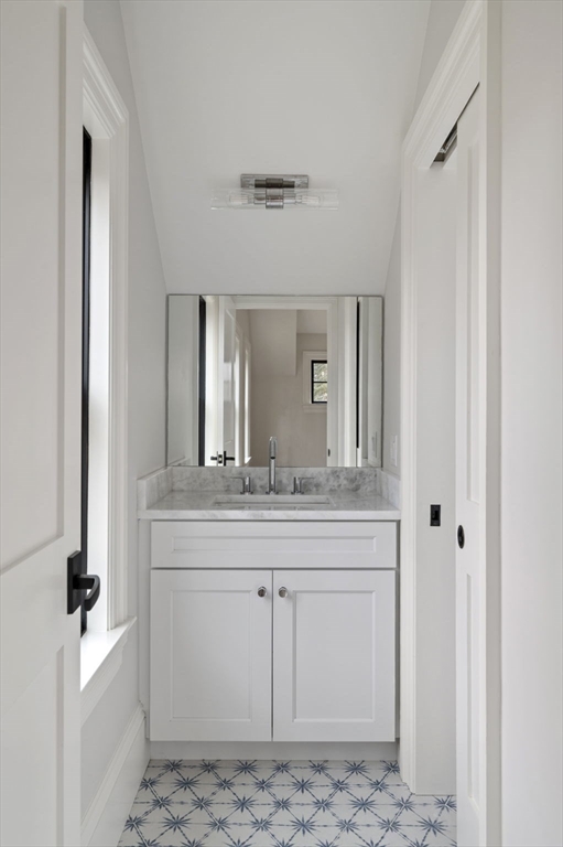 16 Liberty Road Marblehead, MA 01945 - Photo 33 of 42 a bathroom with a granite countertop sink and a mirror