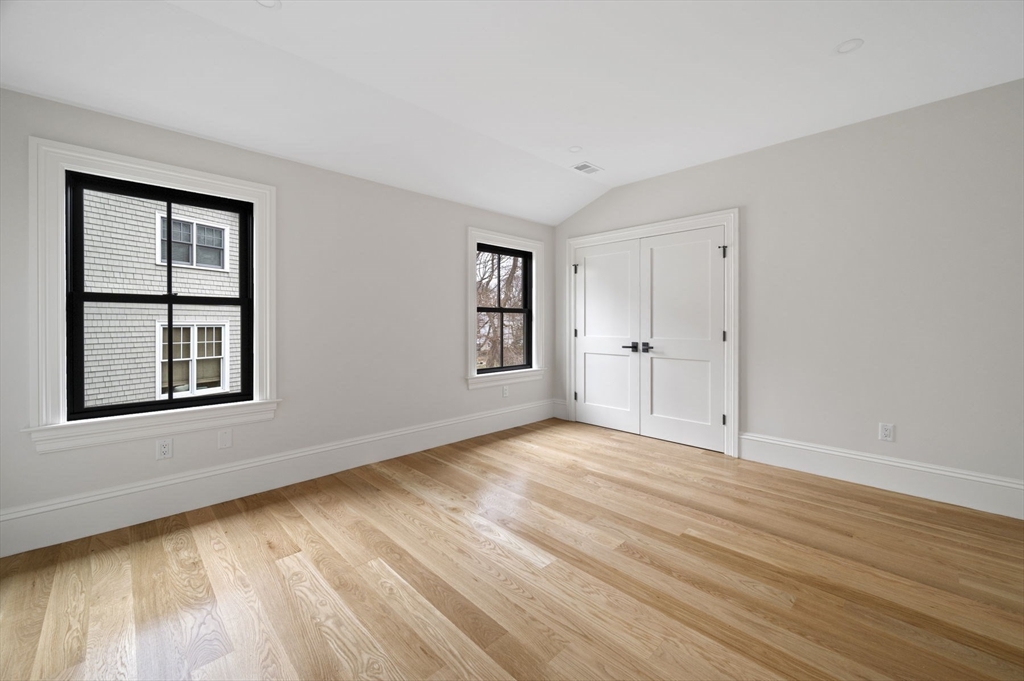 16 Liberty Road Marblehead, MA 01945 - Photo 37 of 42 a view of an empty room with window and wooden floor