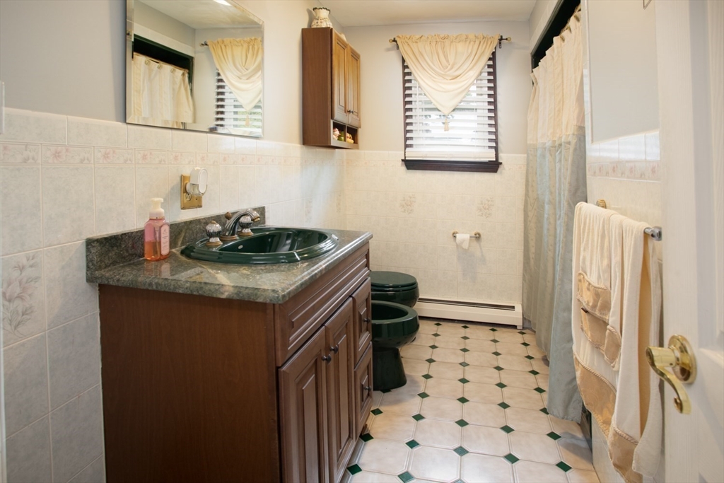 166 Stonehaven Road Fall River, MA 02723 - Photo 12 of 33 a bathroom with a granite countertop sink a toilet a shower and a mirror