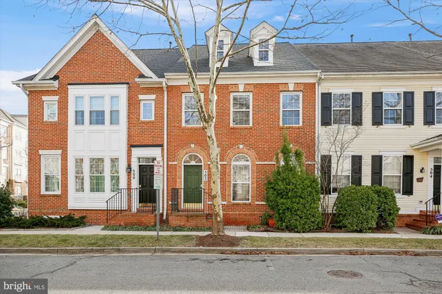 front view of a brick house with a small yard