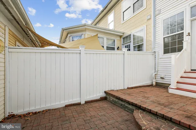 a bathroom with a sink a mirror and a fan