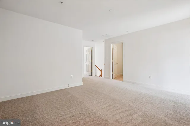 a view of an empty room with stairs and stairs