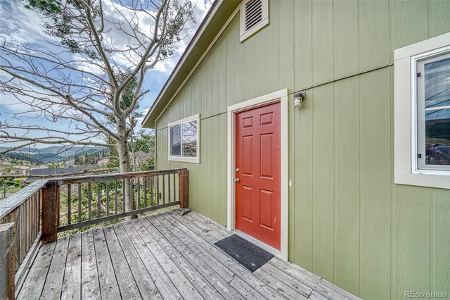 a living room with furniture potted plant and window
