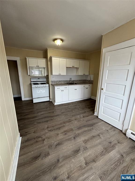 a kitchen with stainless steel appliances wooden cabinets and wooden floor