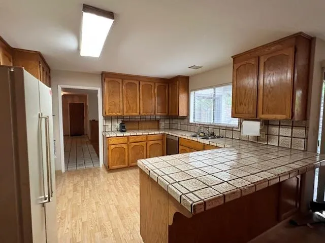 a kitchen with a stove a sink and a refrigerator