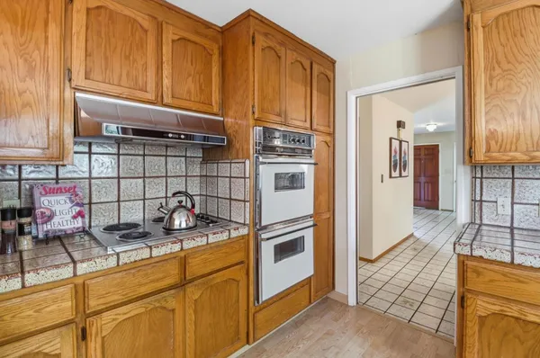a spacious bedroom with a bed and wooden floor