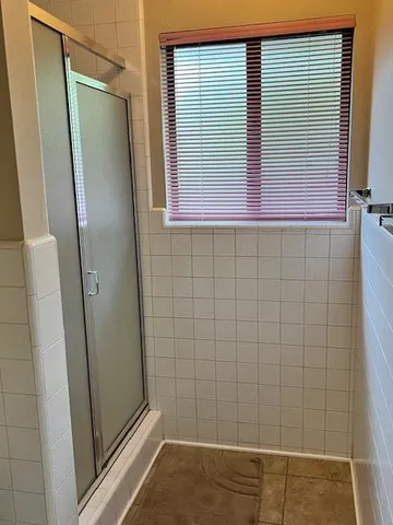 a bathroom with a shower and a sink