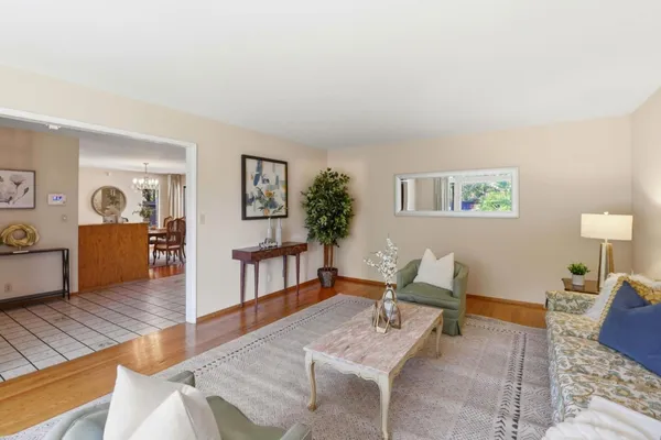 a living room with furniture and wooden floor