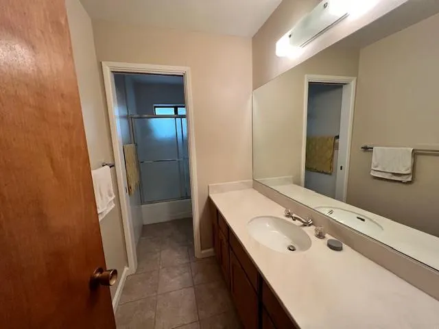a bathroom with a double vanity sink and mirror
