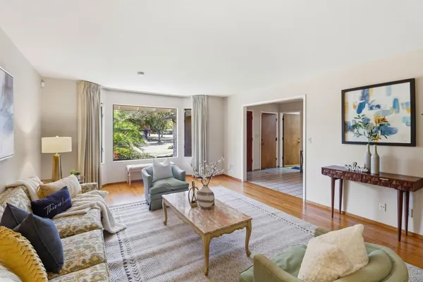 a living room with furniture and a large window
