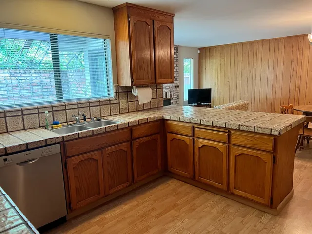 a kitchen with a sink stove and cabinets