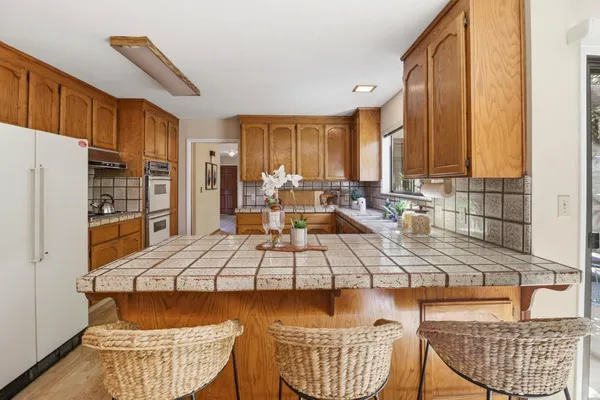 a kitchen with a dining table and chairs
