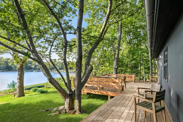 a backyard of a house with table and chairs