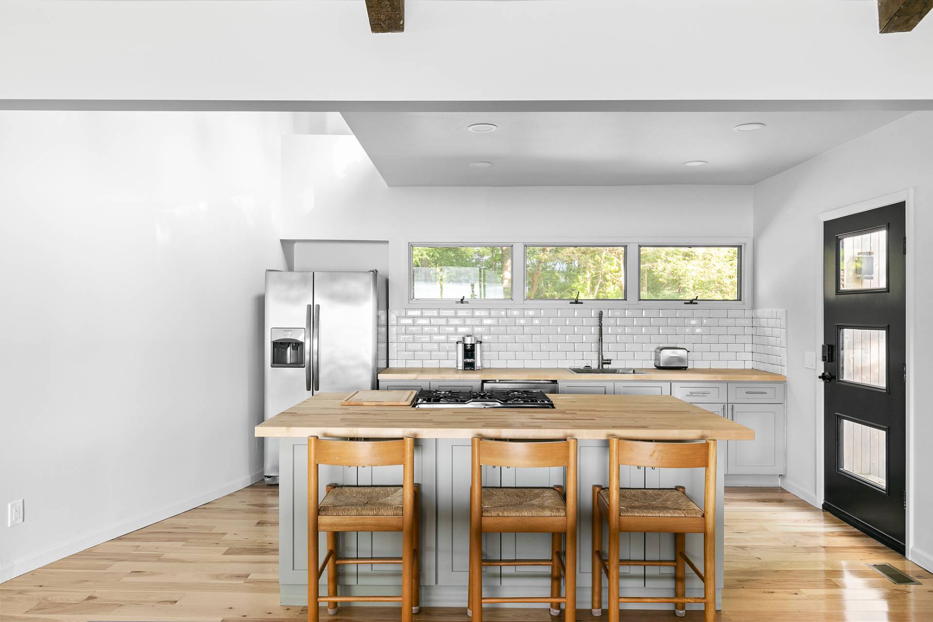 33 Bluff Point Road Sag Harbor, NY 11963 - Photo 3 of 20 a kitchen with granite countertop a stove a sink and a refrigerator
