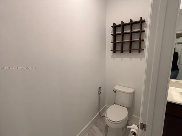a white toilet sitting next to a sink