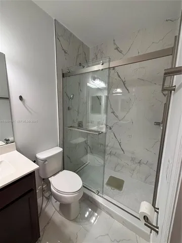 a bathroom with a toilet and a shower