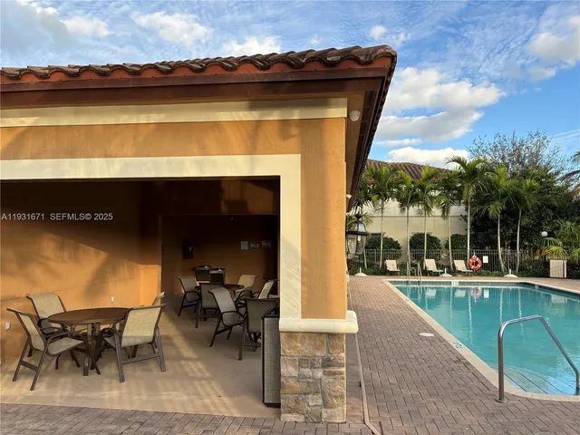 a view of a lake with table and chairs floor to ceiling window