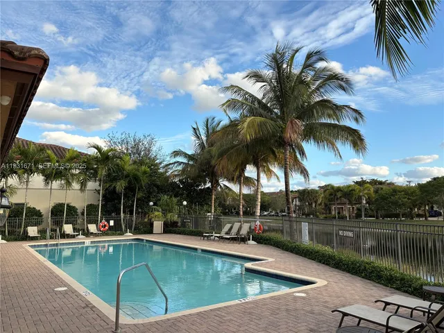 a view of swimming pool with a table and chairs
