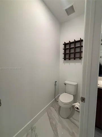 a bathroom with a toilet and a sink